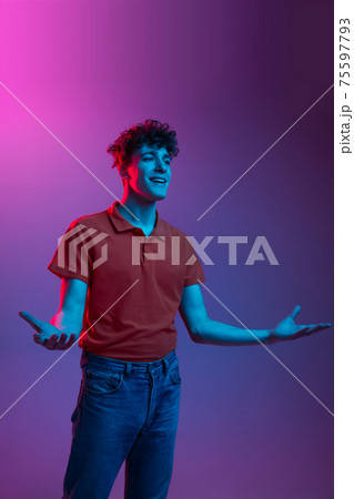Portrait of man in casual clothes isolated on gradient background in neon light 75597793