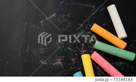 Colored chalk on a blackboard. Blackboard with crayons. The concept of school 75598163