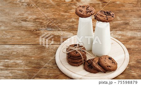 Homemade Chocolate Chip Cookies and Milk on wooden background in rustic style Homemade Chocolate Chip Cookies and Milk on wooden background in rustic style 75598879