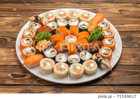A large beautiful sushi set with maki rolls, nigiri and gunkans A large beautiful sushi set with maki rolls, nigiri and gunkans 75599617