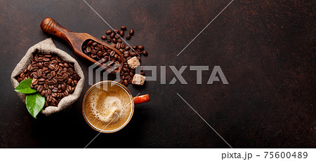 Roasted coffee beans, brown sugar and espresso cup Roasted coffee beans, brown sugar and espresso cup 75600489