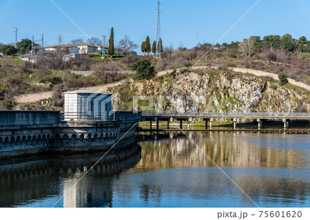 View of the dam of El VIllar a sunny day in Madrid, Spain View of the dam of El VIllar a sunny day in Madrid, Spain 75601620