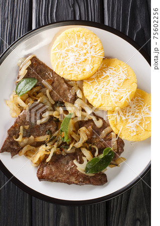 Fegato alla Veneziana Calf's Liver and Onions with polenta closeup in the plate. Vertical top view Fegato alla Veneziana Calf's Liver and Onions with polenta closeup in the plate. Vertical top view 75602256