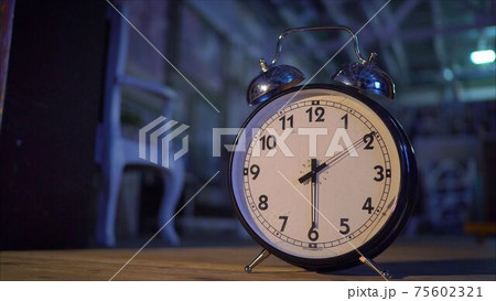 Retro alarm clock on table. Vintage style sepia photo. Big alarm clock Retro alarm clock on table. Vintage style sepia photo. Big alarm clock 75602321