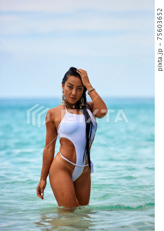 Sexy girl in a white swimsuit posing at the. 75603652 PIXTA