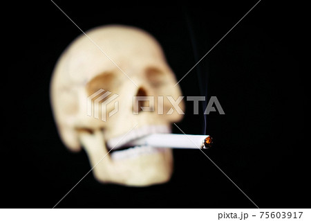 Skull And Burning Cigarette Death From Smoking の写真素材