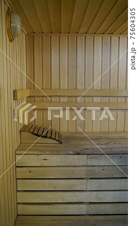 Sauna accessories are in the interior of the steam room. The interior of the sauna. Sauna from linden. Sauna accessories are in the interior of the steam room. The interior of the sauna. Sauna from linden. 75604305