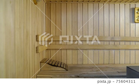 Sauna accessories are in the interior of the steam room. The interior of the sauna. Sauna from linden. 75604311