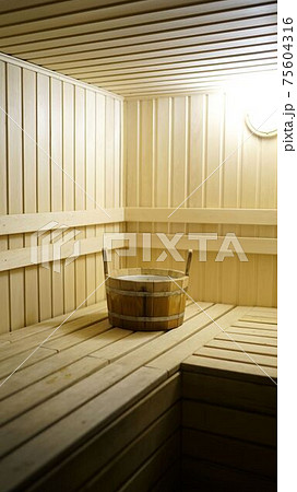 Sauna accessories are in the interior of the steam room. The interior of the sauna. Sauna from linden. 75604316