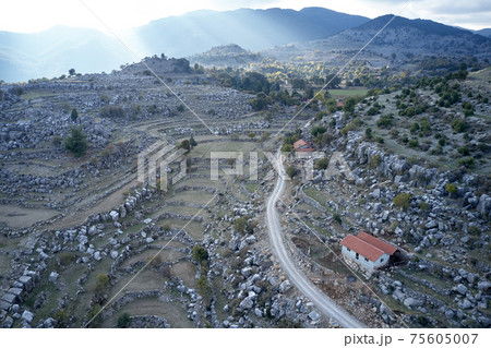 Aerial view of the road in mountain valley. Aerial view of the road in mountain valley. 75605007