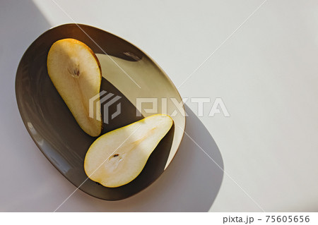 Modern minimal still life, pears on a plate in natural light. Modern minimal still life, pears on a plate in natural light. 75605656