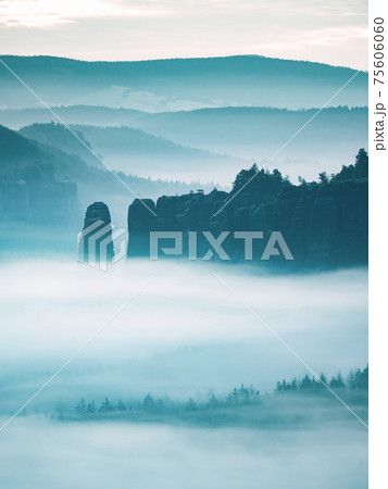 Mountain peak outline in blue night mist.  Row of foggy mountain ranges 75606060