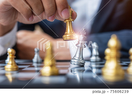 businessman hand moving gold Chess King figure and Checkmate opponent during chessboard competition. Strategy, Success, management, business planning, disruption and leadership concept businessman hand moving gold Chess King figure and Checkmate opponent during chessboard competition. Strategy, Success, management, business planning, disruption and leadership concept 75606239