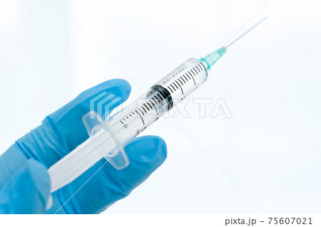 Close up vaccines fight against virus, doctor or scientist in laboratory holding a syringe with liquid vaccines. Close up vaccines fight against virus, doctor or scientist in laboratory holding a syringe with liquid vaccines. 75607021