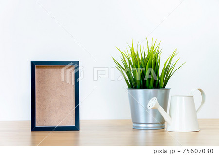 black square frames and green plant on wooden table, black square frames and green plant on wooden table, 75607030