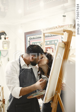 Mixed couple painting in a class 75607484