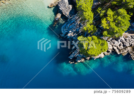 Mediterranean sea. Aerial view on water and rocks during sunset. Vacation and adventure. Mediterranean sea. Aerial view on water and rocks during sunset. Vacation and adventure. 75609289