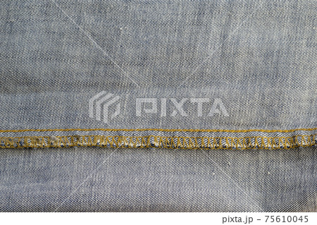 Wrong side of jeans fabric. Detailed shot of the classic yellow threaded fabric. Copy space Wrong side of jeans fabric. Detailed shot of the classic yellow threaded fabric. Copy space 75610045