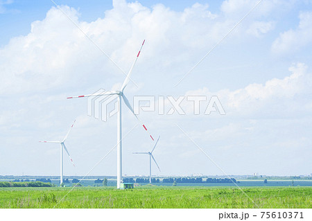 many windmills stand on a large field many windmills stand on a large field 75610371