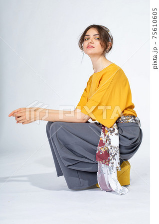 Young white girl on light grey 75610605