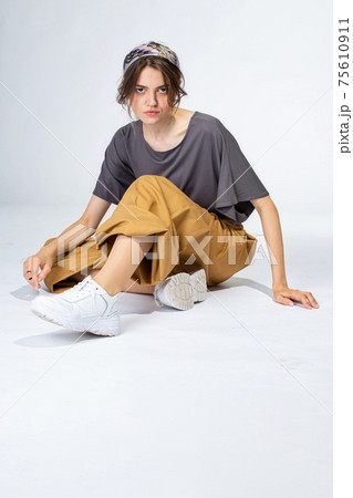 Young white girl on light grey 75610911