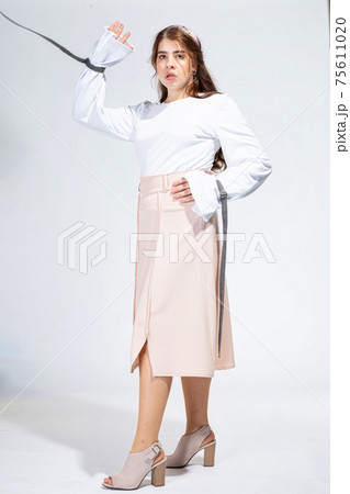Young white woman isolated on light grey 75611020