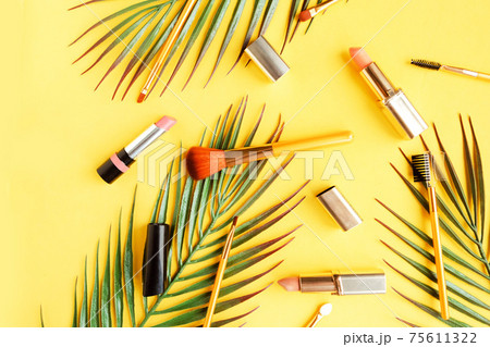 Set of pink lipsticks and makeup brushes on bright yellow background flat lay top view minimal. Beauty and cosmetics background. Decorative cosmetics, makeup, women's lipstick, beauty brand Set of pink lipsticks and makeup brushes on bright yellow background flat lay top view minimal. Beauty and cosmetics background. Decorative cosmetics, makeup, women's lipstick, beauty brand 75611322