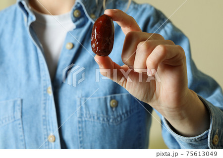 Woman in jeans shirt hold date fruit Woman in jeans shirt hold date fruit 75613049