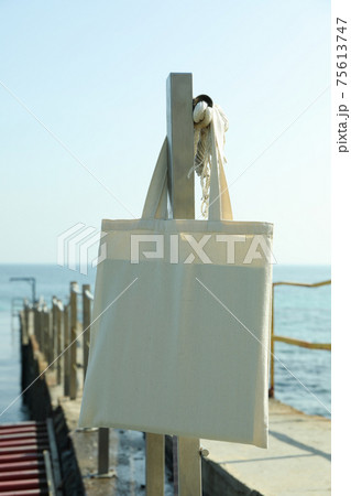 Blank eco bag on pier on the seashore 75613747