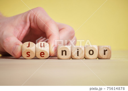 The concept of the generation change into senior and junior in business and life on wooden cubes 75614878