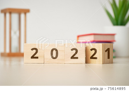 Concept of changing the year from 2021 to 2022 on wooden cubes. Concept of changing the year from 2021 to 2022 on wooden cubes. 75614895