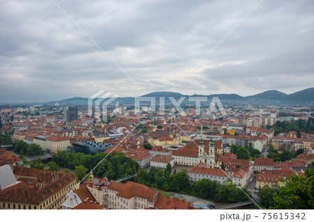 Cityscape of Graz with Mur river and Mariahilfer church (Mariahilferkirche), view from the Shlossberg hill, in Graz, Styria region, Austria Cityscape of Graz with Mur river and Mariahilfer church (Mariahilferkirche), view from the Shlossberg hill, in Graz, Styria region, Austria 75615342