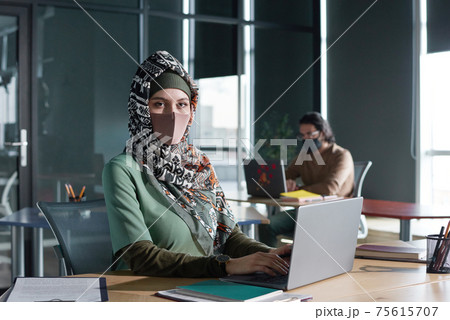 Muslim woman working on laptop 75615707