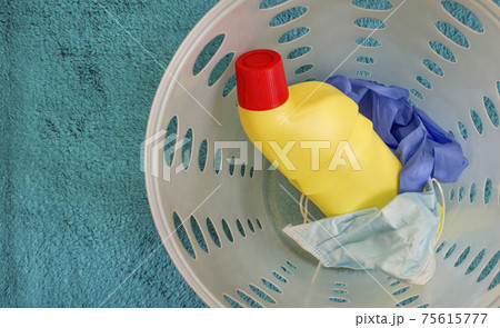 Medical masks, gloves and disinfectant bottle thrown in the trash, end of quarantine and disease coronavirus COVID-19 concept. Medical waist. Selective focus 75615777