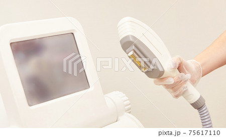 Medical beauty laser cosmeology procedure. Young female at salon. Professional doctor. Woman skincare technology. Hair removal 75617110