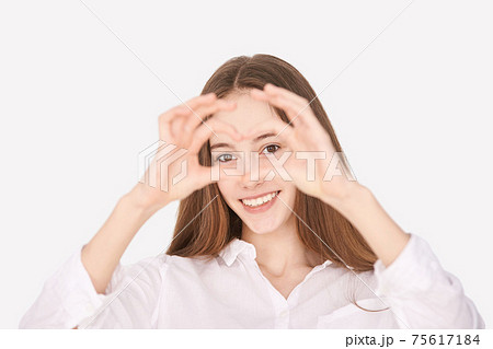 Heart hands near face. Positive emotion model. Ophthalmology concept 75617184