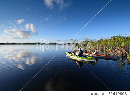 Woman and active senior kayaking on Nine Mile Pond in Everglades National Park. 75619808