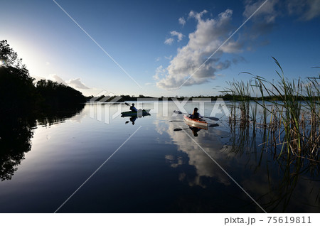 Woman and active senior kayaking on Nine Mile Pond in Everglades National Park. 75619811