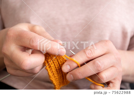Women's hands knit. Handmade creative working concept 75622988