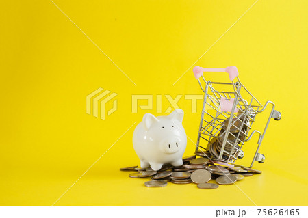 White piggy shopping cart with coins thai baht on yellow background. 75626465