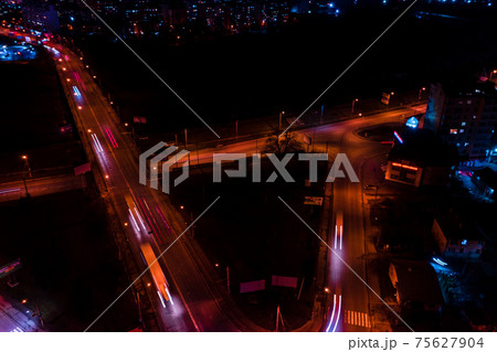 Night streets, highway and car traffic in the city of Ivano-Frankivsk, lights from car traffic, top view of the street. 75627904