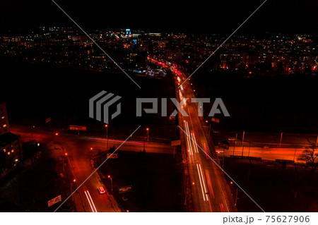 Night streets, highway and car traffic in the city of Ivano-Frankivsk, lights from car traffic, top view of the street. 75627906