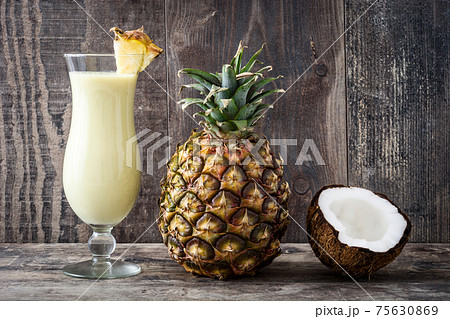 Pina colada cocktail decorated with a piece of pineapple and coconut fruit Pina colada cocktail decorated with a piece of pineapple and coconut fruit 75630869