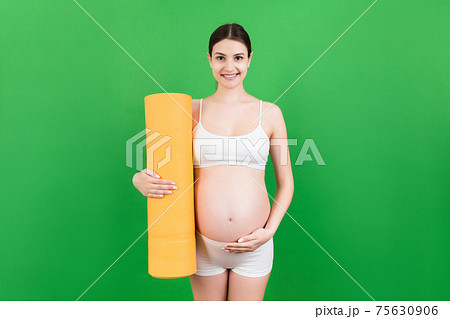 Pregnant Girl Holding Yoga Mat Standing Over Colored Background. Studio Shot, Free Space For Design Pregnant Girl Holding Yoga Mat Standing Over Colored Background. Studio Shot, Free Space For Design 75630906