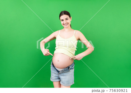 Young beautiful teenager girl pregnant expecting baby over isolated colored background smiling showing big belly Young beautiful teenager girl pregnant expecting baby over isolated colored background smiling showing big belly 75630921