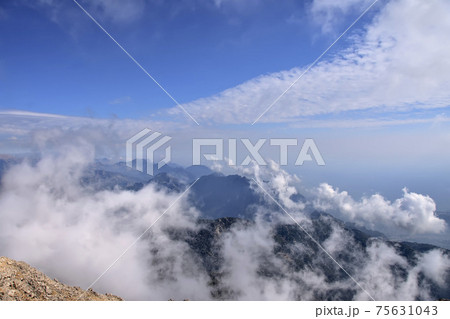 aerial view, view of the peaks of the Taurus Mountains, blue sky and clouds 75631043