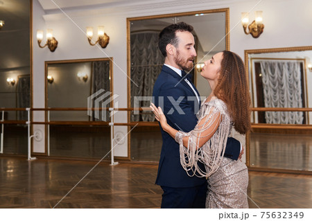 adult couple dancing classical partner dance in empty ballhall 75632349