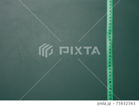 green measuring tape on green board 75632563