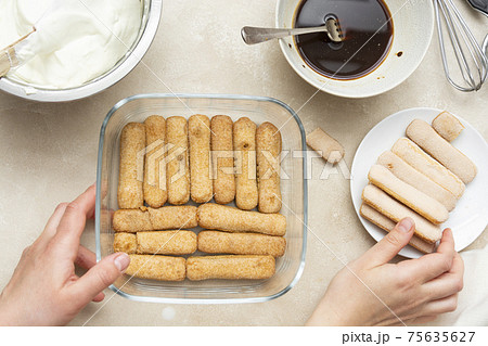 Cooking tiramisu cake with sponge fingers cookies. Step by step recipe. Top view. 75635627