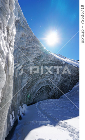 High ice wall in mountains. Bogdanovich Glacier High ice wall in mountains. Bogdanovich Glacier 75636719